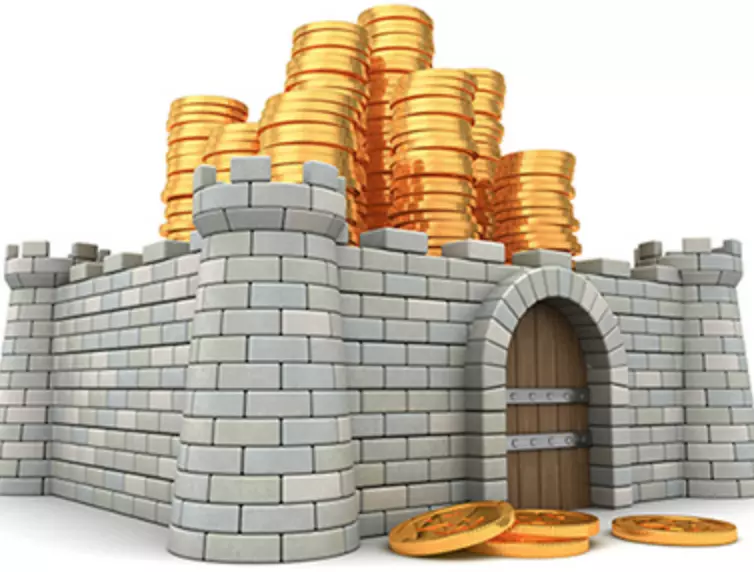 Model of a castle with gold coins stacked on top